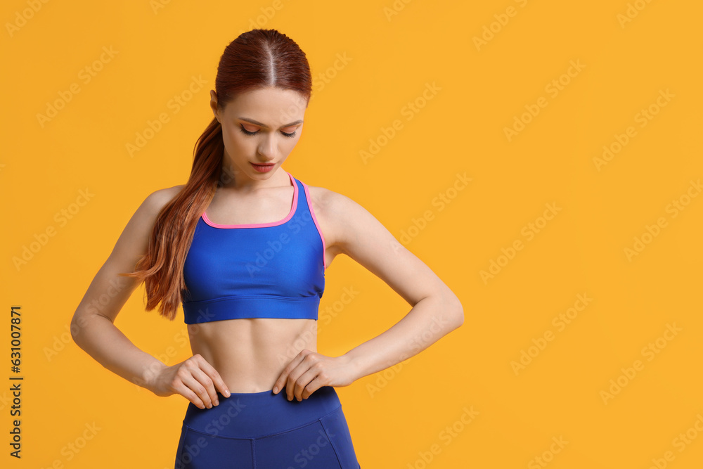 Young woman wearing sportswear on yellow background, space for text Young woman wearing sportswear on yellow background, space for text