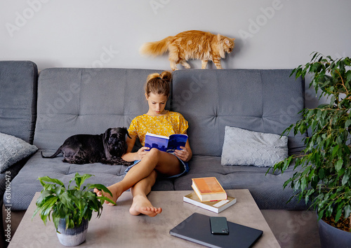 digital detox and leisure concept. girl reading book at home