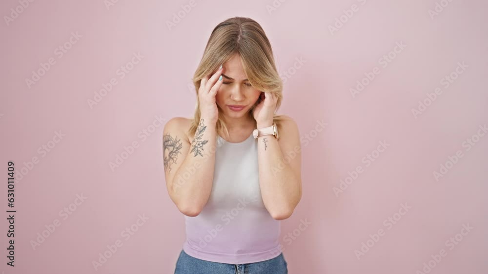 Young blonde woman stressed standing over isolated pink background Young blonde woman stressed standing over isolated pink background