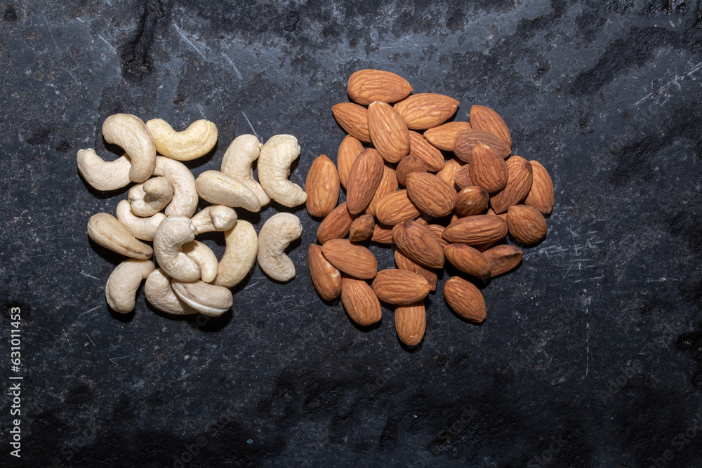 Cashew and Almond on stone or concrete background Cashew and Almond on stone or concrete background