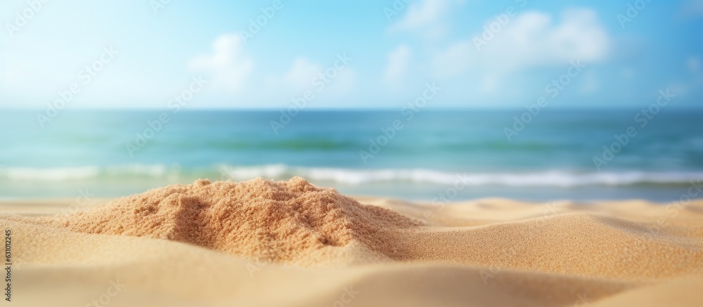 Close-up shot of sand with a blurred background of the sea and sky on a summer day. Suitable for product Close-up shot of sand with a blurred background of the sea and sky on a summer day. Suitable for product
