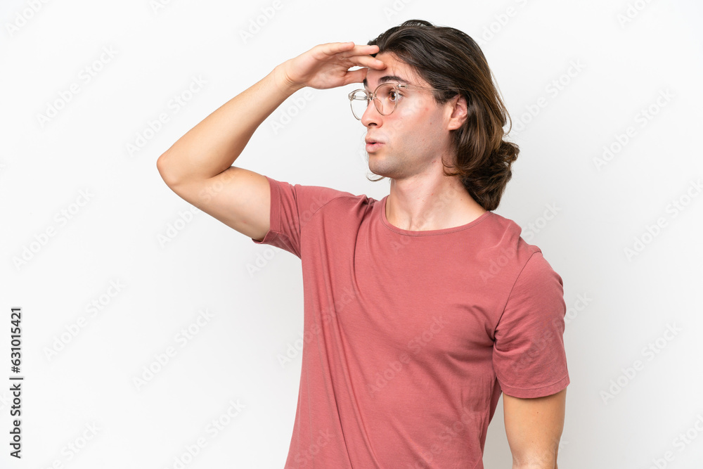 Young handsome man isolated on white background with surprise expression while looking side Young handsome man isolated on white background with surprise expression while looking side