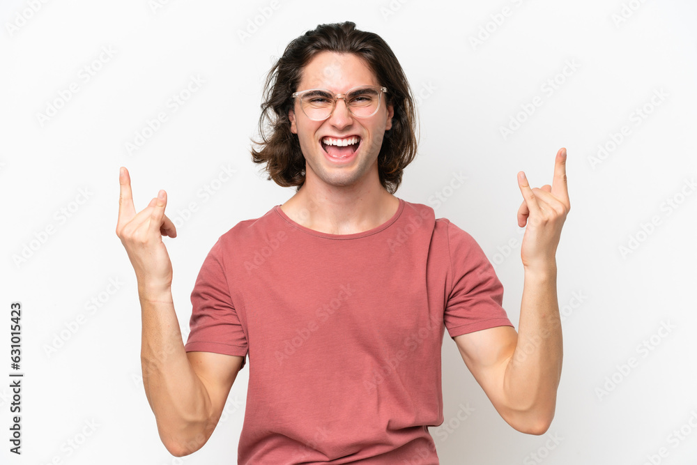 Young handsome man isolated on white background making horn gesture Young handsome man isolated on white background making horn gesture