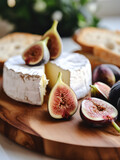 cheese and figs, soft camembert cut and served with fruit and bread, close-up photo, soft focus, cheese plate, food photography