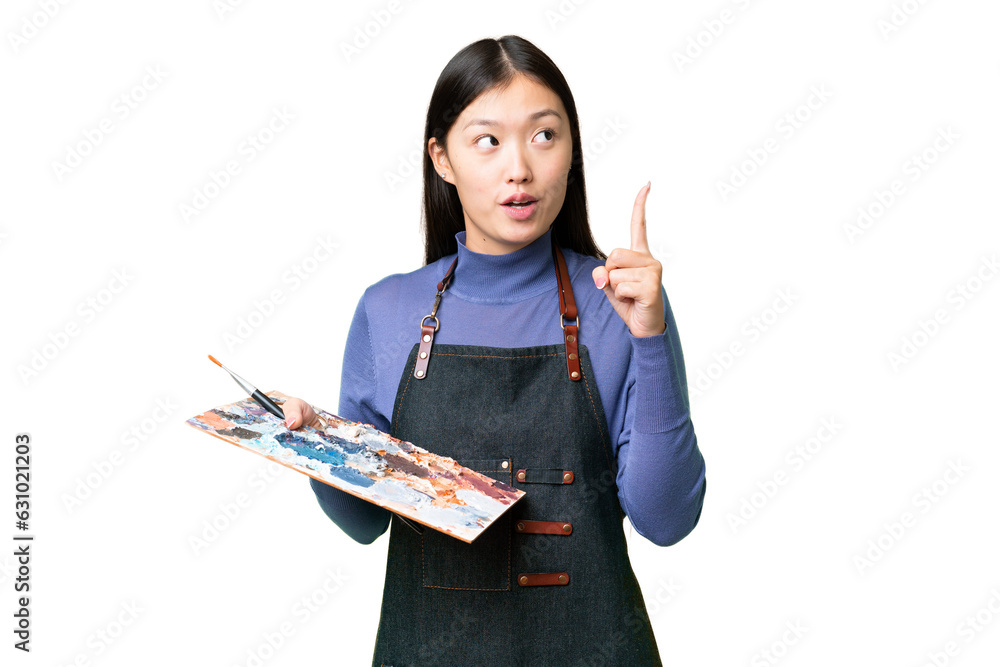 Young artist woman holding a palette over isolated chroma key background thinking an idea pointing the finger up Young artist woman holding a palette over isolated chroma key background thinking an idea pointing the finger up