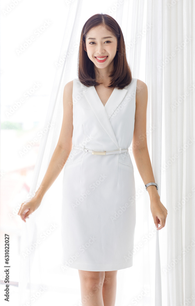 Portrait isolated cutout studio shot of Asian beautiful professional successful female businesswoman ceo entrepreneur in casual business wear standing smiling posing crossed arms on white background Portrait isolated cutout studio shot of Asian beautiful professional successful female businesswoman ceo entrepreneur in casual business wear standing smiling posing crossed arms on white background