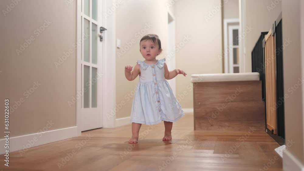 baby first steps. daughter a baby toddler learning to walk take first steps. happy family kid dream concept. lifestyle baby indoors learning to walk indoors. baby training concept
