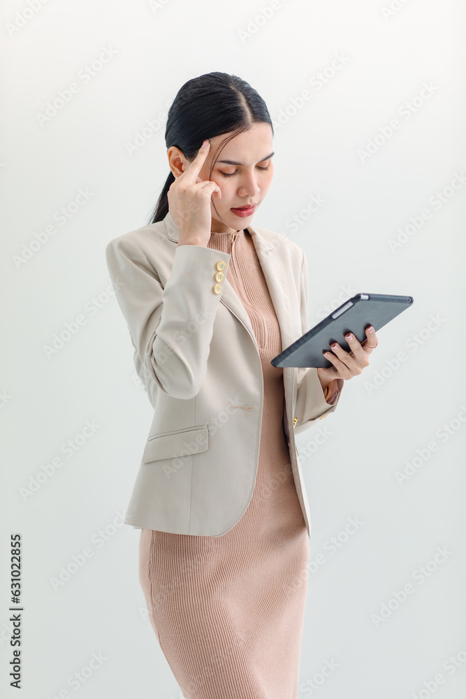 Isolated cutout studio shot Asian young professional successful female businesswoman secretary in formal business suit wear standing using tablet surfing browsing internet online on white background Isolated cutout studio shot Asian young professional successful female businesswoman secretary in formal business suit wear standing using tablet surfing browsing internet online on white background