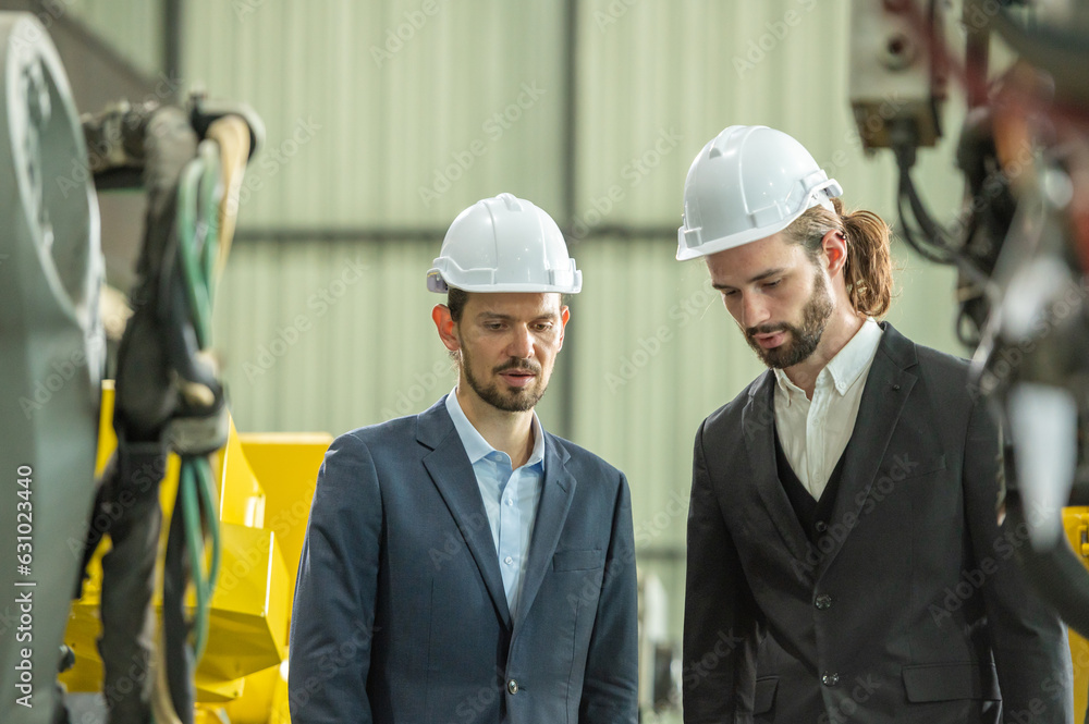 Group partner engineer assistant in helmet inspection check heavy machine construction installation in industrial metal roof roll sheet factory with colleague manager. partnership operation factory Group partner engineer assistant in helmet inspection check heavy machine construction installation in industrial metal roof roll sheet factory with colleague manager. partnership operation factory