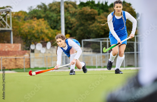 Fitness, workout and female hockey players training for a game, match or tournament on an outdoor field. Sports, exercise and young women playing at practice with a stick and ball on pitch at stadium