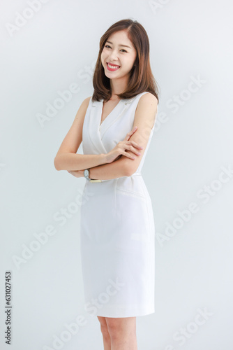 Portrait isolated cutout studio shot of Asian beautiful professional successful female businesswoman ceo entrepreneur in casual business wear standing smiling posing crossed arms on white background