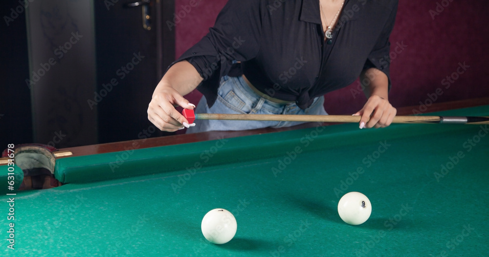 Fototapeta premium Caucasian young girl playing billiards.