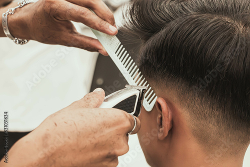 Close-up professional hairdresser using scissors and clippers and accessories for beautiful and decorating men hair Cutting hair for male customer, barbershop fashion and beauty hipster style concept © ART STOCK CREATIVE