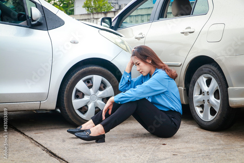 Stressed Asian woman holding her head sitting on the road Look at the cars that were hit. Transportation concept. car accident insurance © SUPERMAO