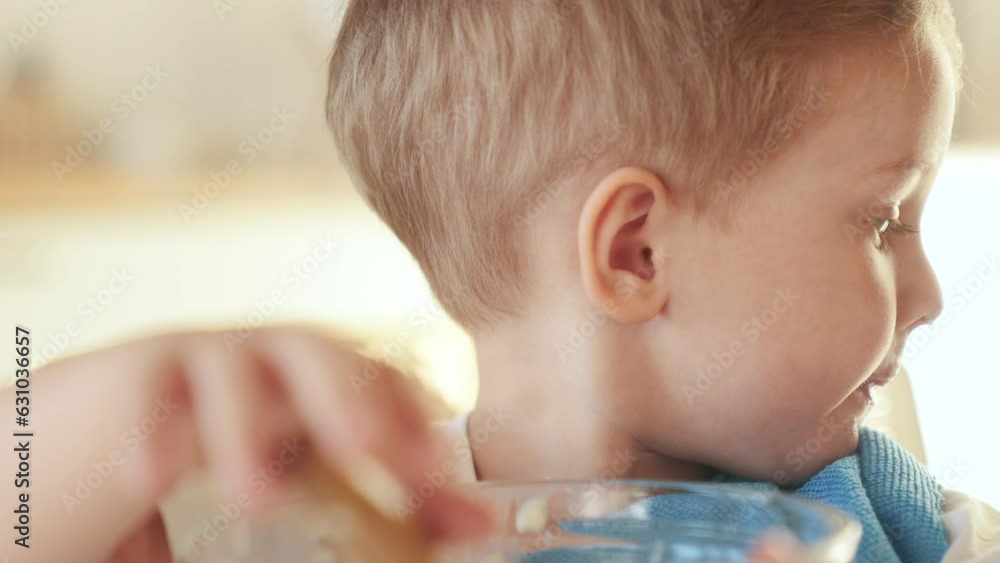 the child does not want to eat porridge. happy family healthy food concept. the boy little son eats porridge with a spoon soiled in his face. child fun dirty eating porridge himself video the child does not want to eat porridge. happy family healthy food concept. the boy little son eats porridge with a spoon soiled in his face. child fun dirty eating porridge himself video