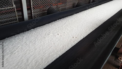 Mineral fertilizers are transported by conveyor belt on chemical plant.