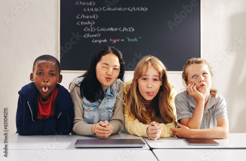Diverse elementary school children making funny faces in a coding class