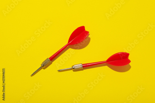 Darts for hitting the target on a yellow background.