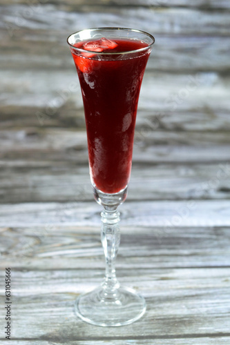 Fresh refrigerated Roselle juice glass made from boiling dried Roselle herbs in water, a bissap wonjo juice, flowers of the Roselle plant Hibiscus, sweetened and chilled served with ice cubes photo