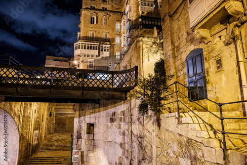 Fototapeta Naklejka Na Ścianę i Meble -  the empty streets of Valletta at night. Street lights illuminate the old houses