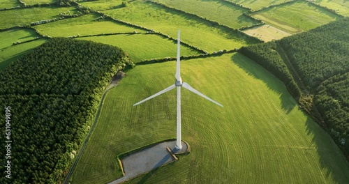 A drone flying over wind turbines in a picturesque valley in the countryside