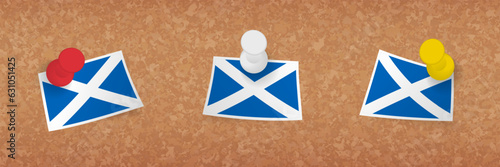 Scotland flag pinned in cork board, three versions of Scotland flag.