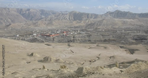 The stunning landscapes of Upper Mustang with the former capital of the Kingdom of Lo, Lo Manthang, Nepal. The walled city sits at an altitude of around 4000m. photo