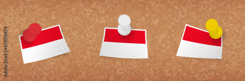 Monaco flag pinned in cork board, three versions of Monaco flag.