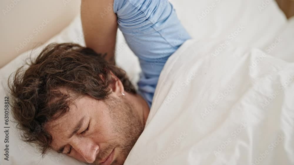 Young hispanic man lying on bed stressed at bedroom Young hispanic man lying on bed stressed at bedroom