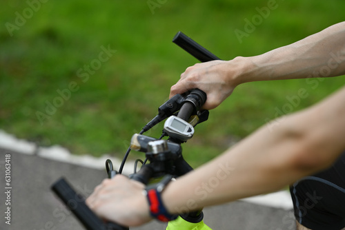 Unrecognizable sporty man riding a bicycle on country road. Travel, sport and active lifestyle concept.
