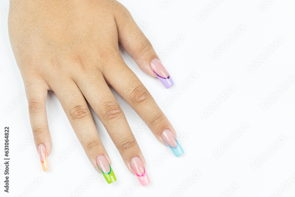 Colorful nails art on the woman hand above white background Colorful nails art on the woman hand above white background
