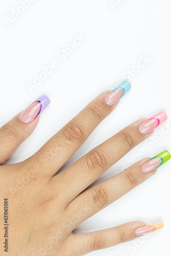 Colorful nails art on the woman hand above white background