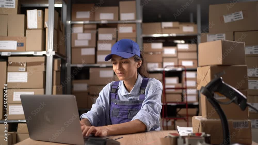 Happy warehouse female worker with laptop computer in the warehouse, raised arms with cheering. She got raise because worthy and productive. Happy warehouse female worker with laptop computer in the warehouse, raised arms with cheering. She got raise because worthy and productive.