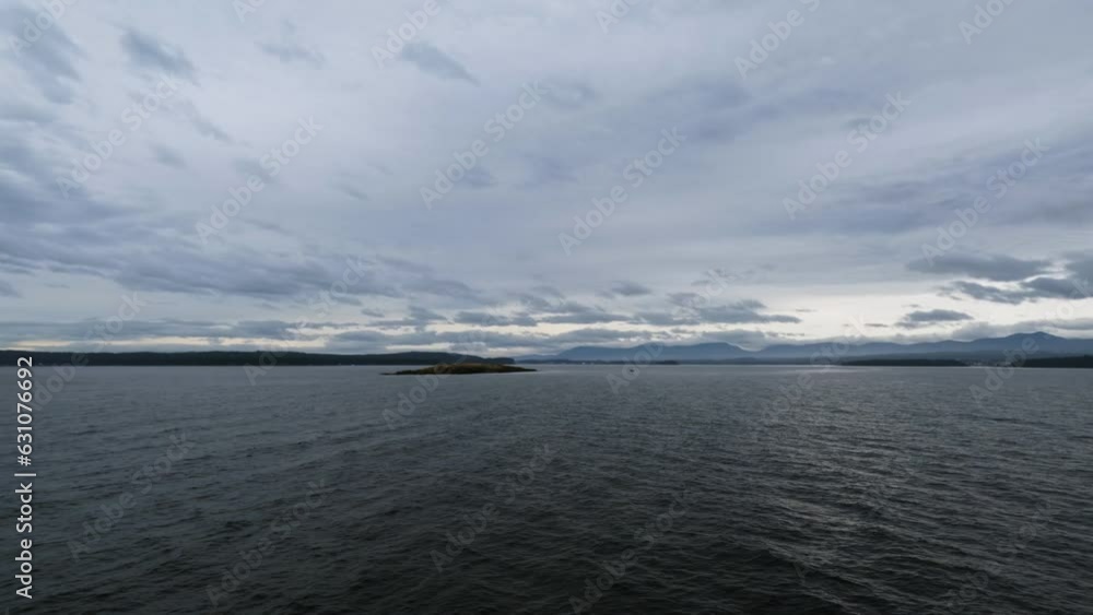 Calm Waters With Cloudy Sky Scenery In Vancouver Island In Canada. wide, sideways Calm Waters With Cloudy Sky Scenery In Vancouver Island In Canada. wide, sideways