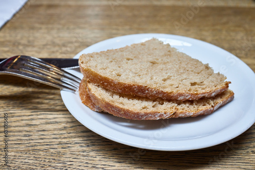 Basic food. Plate with several slices of bread and some cutlery