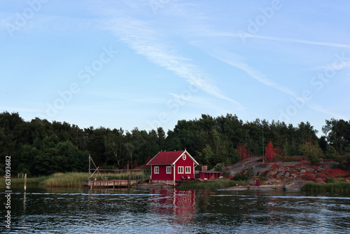 red wooden hut in a forest in Sweden by a lake. Peace in nature and ideal place for vacation