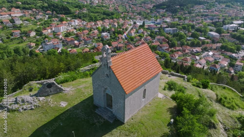 Restored old medieval chapel over Croatian town Sinj on a summer day, aerial Restored old medieval chapel over Croatian town Sinj on a summer day, aerial
