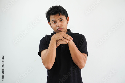 young asian man posing scared and afraid wearing black polo t shirt isolated on white background