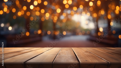 A wooden table top with blurry lights in the background