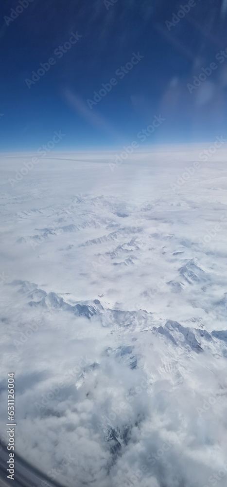 flight view over the snow-capped Alps is a breathtaking spectacle that unfolds like a majestic painting. As the plane soars above these towering peaks, the landscape transforms into a pristine winter 