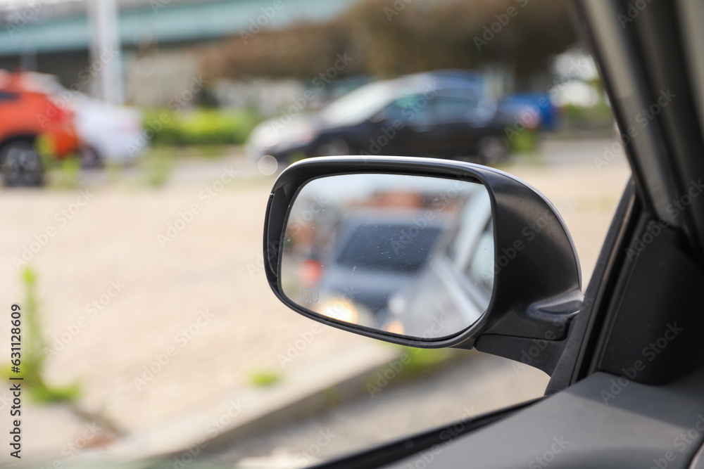 Car mirror reflects life's journeys, offering introspection and foresight. Symbolizes reflection, self-awareness and moving forward
