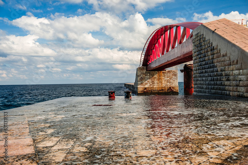 The surf splashes against the St Elmo Breakwater and the spray whips up to the St Elmo Bridge photo