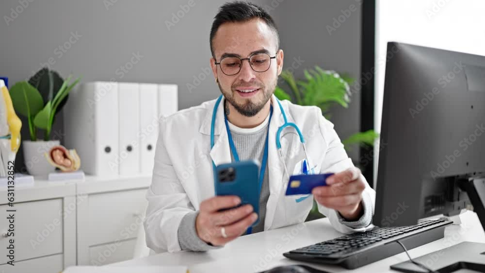Hispanic man doctor using smartphone working doing online shopping at the clinic Hispanic man doctor using smartphone working doing online shopping at the clinic