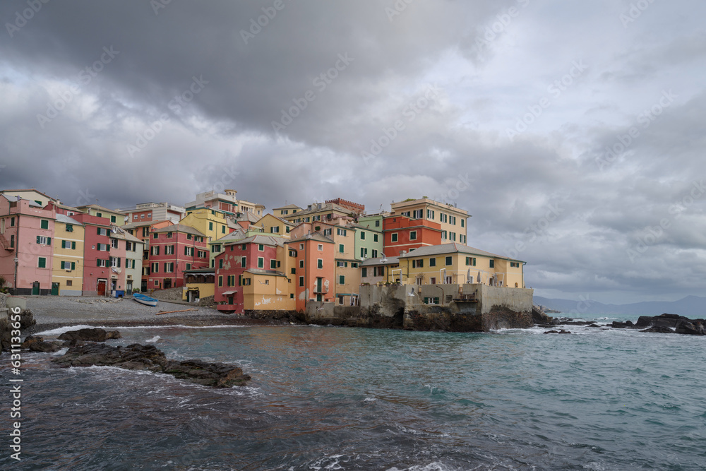 Boccadasse townscape by sea against storm clouds, Genoa, Italy