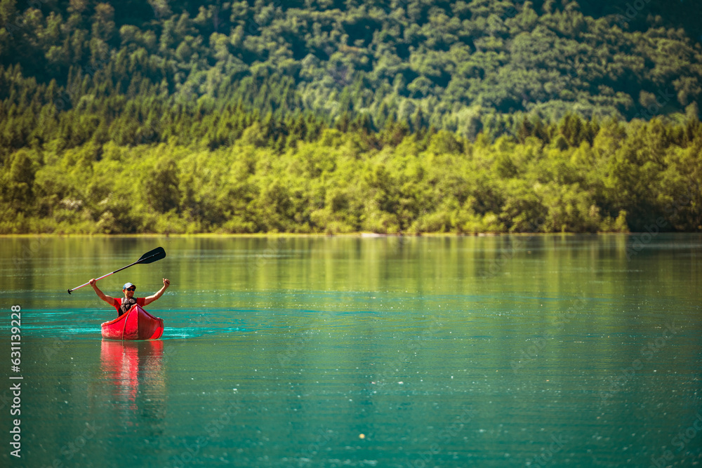 Happy Traveler Inside Red Canoe on a Glacial Lake
