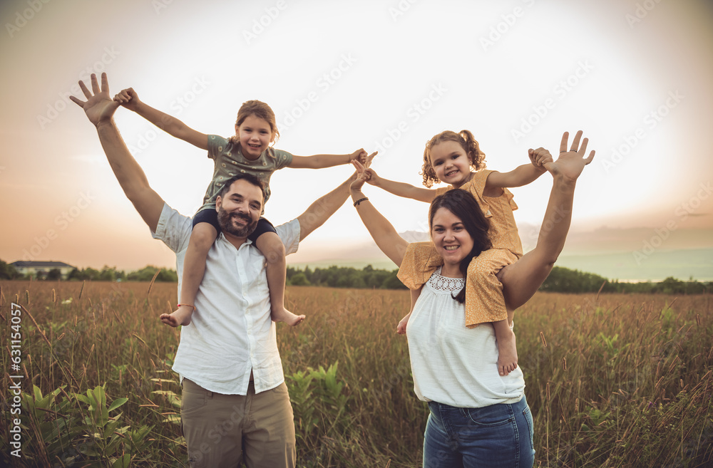 Fototapeta premium Happy family mother father and children daughter on nature sunset
