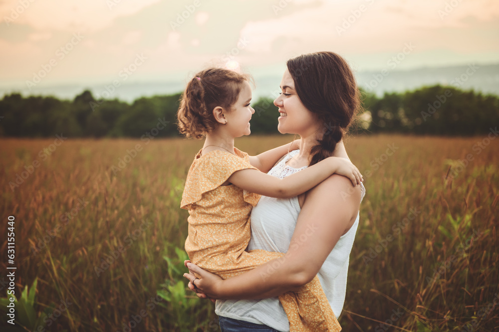 Happy family mother with children daughter on nature sunset Happy family mother with children daughter on nature sunset