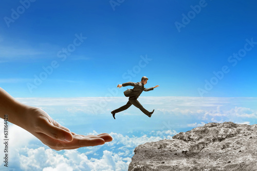 Big hand help businessman jumping on top mountain 3d illustration