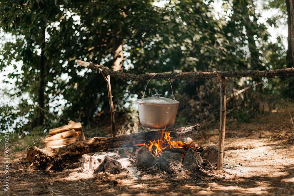 Cooking food on a fire in a pot. Tourist camp.