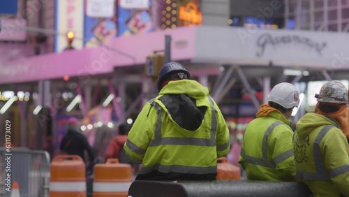 Union workers in hi-vis jackets take a break in midtown Manhattan